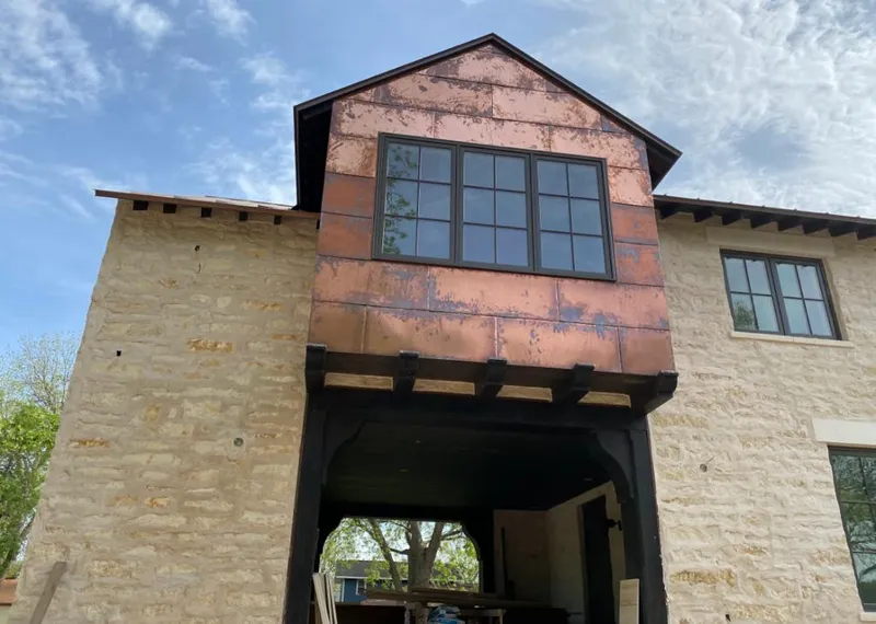 Copper metal panel facade on a stone building for Skylight Installation in Lodi